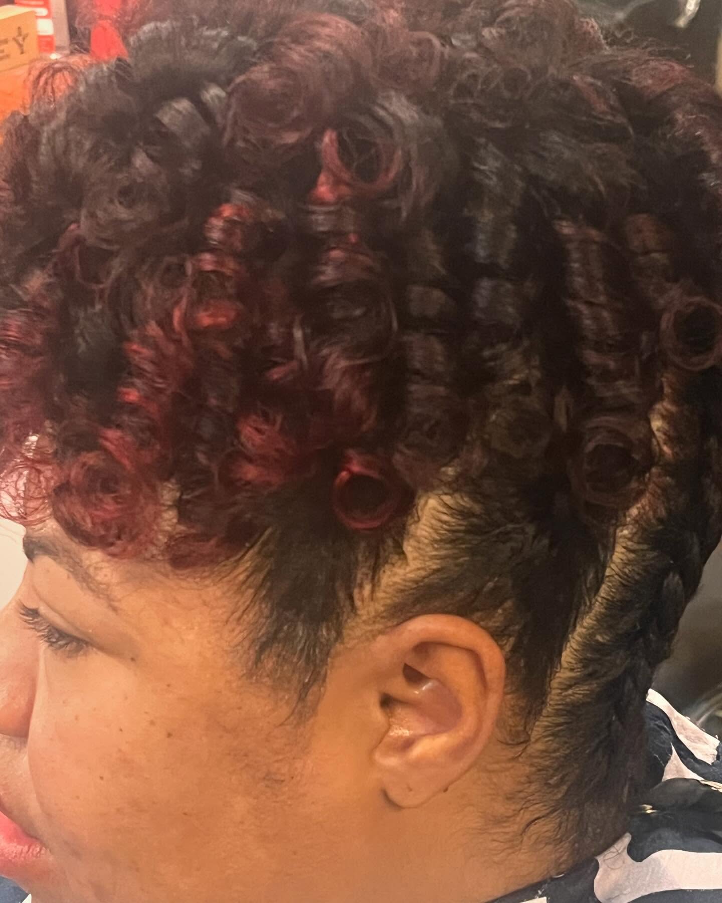 Curly hair with burgundy highlights